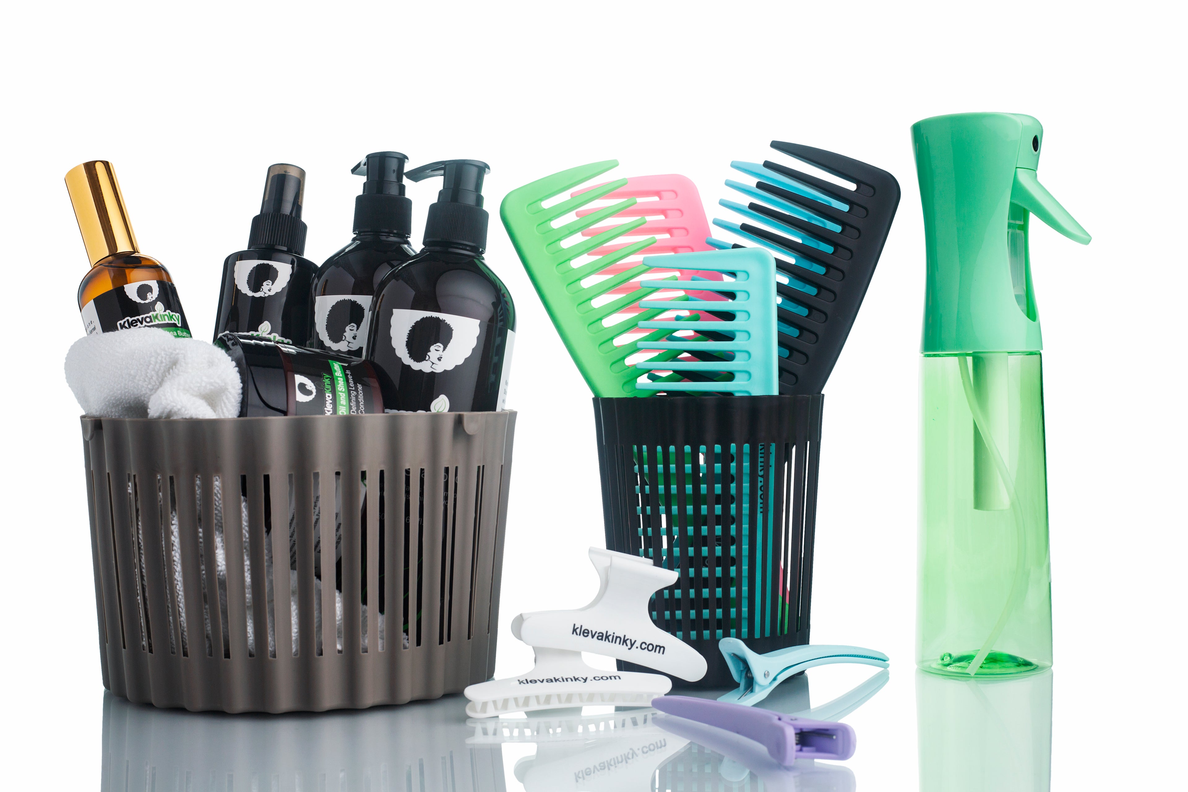 Hair care products, including bottles, combs, hair clips, and a mist spray bottle on a reflective surface.